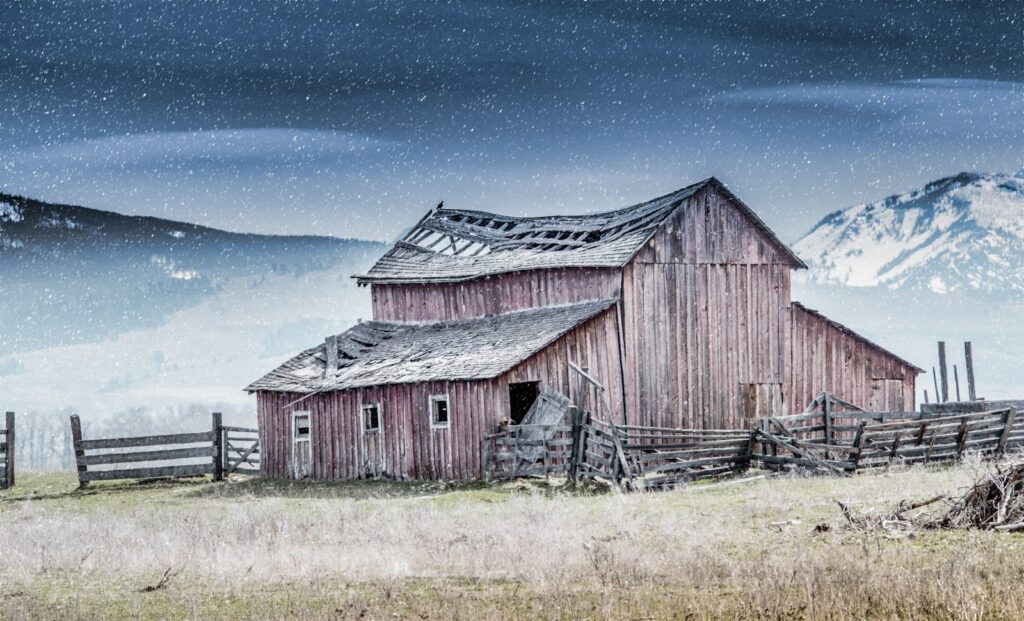 Weathered brown barn beneath a clear blue sky in Montana's Bitterroot Valley, near Stevensville