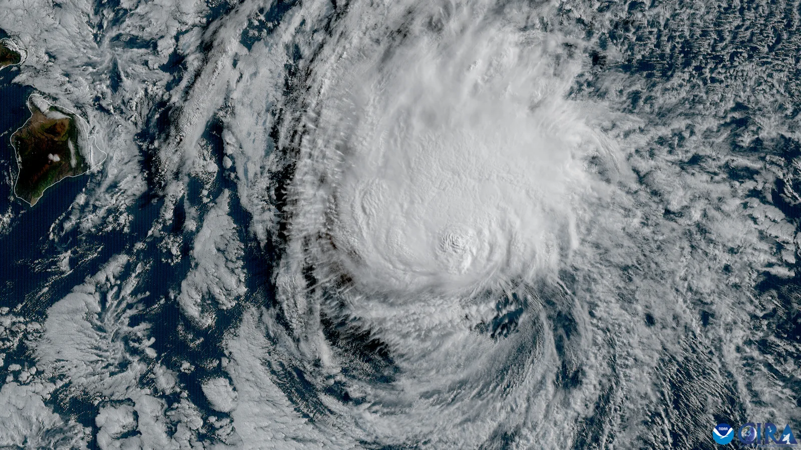 Satellite image showing the swirling cloud bands of a tropical storm system over the Pacific Ocean approaching the Hawaiian Islands